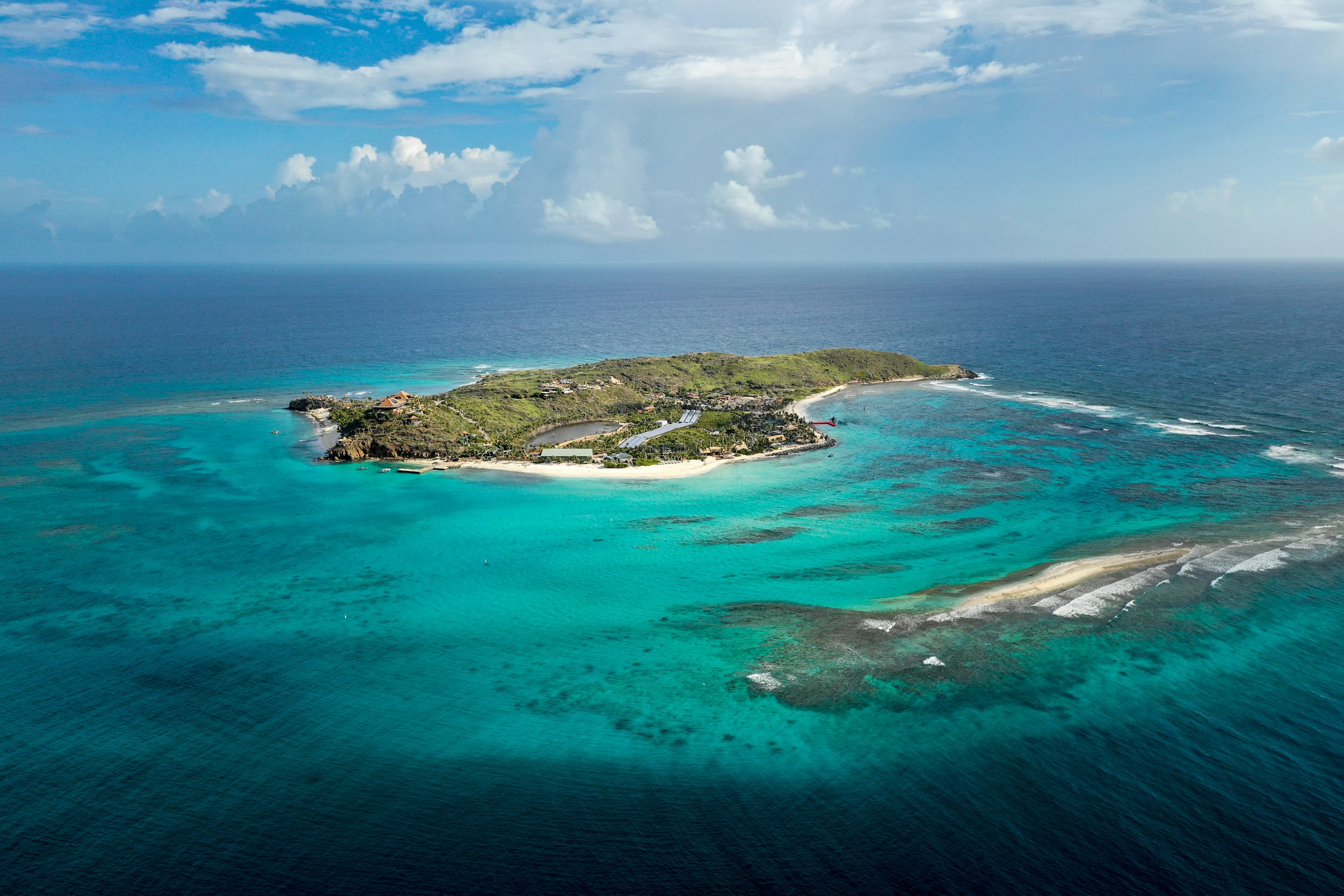 Our catamaran at anchor in bright turquoise water, the kind of week the calendar holds